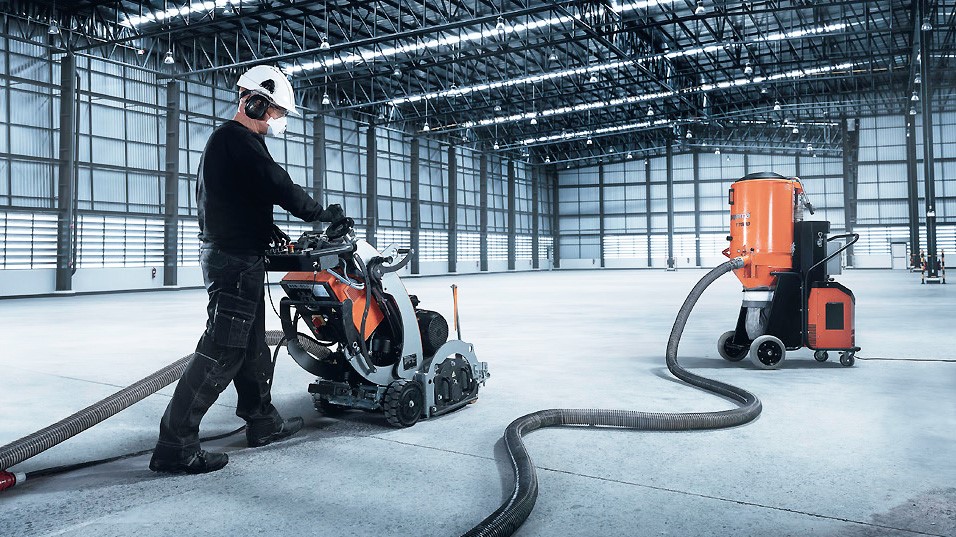 Photo of two Husqvarna floor machines with one being operated