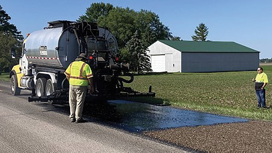 Photo of road crew paving with asphalt incorporating recycled tire scrap