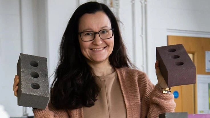 Gabriela Medero poses with the K-Briq, a brick made from 90 percent construction waste.