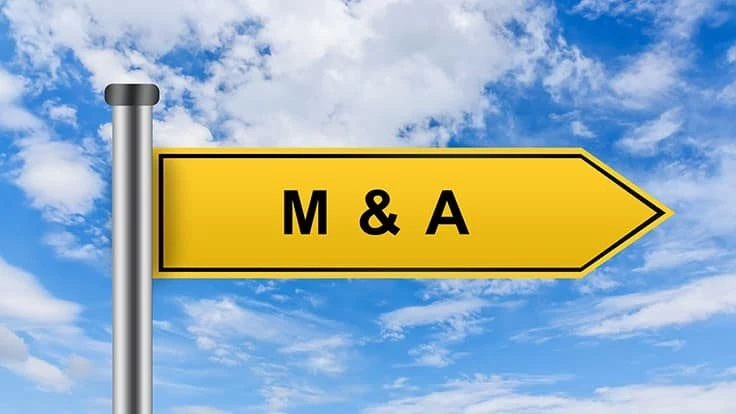 Mergers and acquisitions yellow road sign