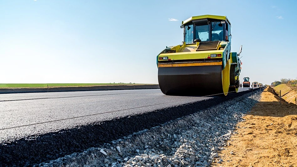 A stream roller on fresh asphalt.