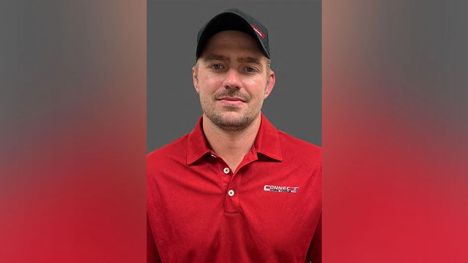 a man wearing a red polo and a black ballcap