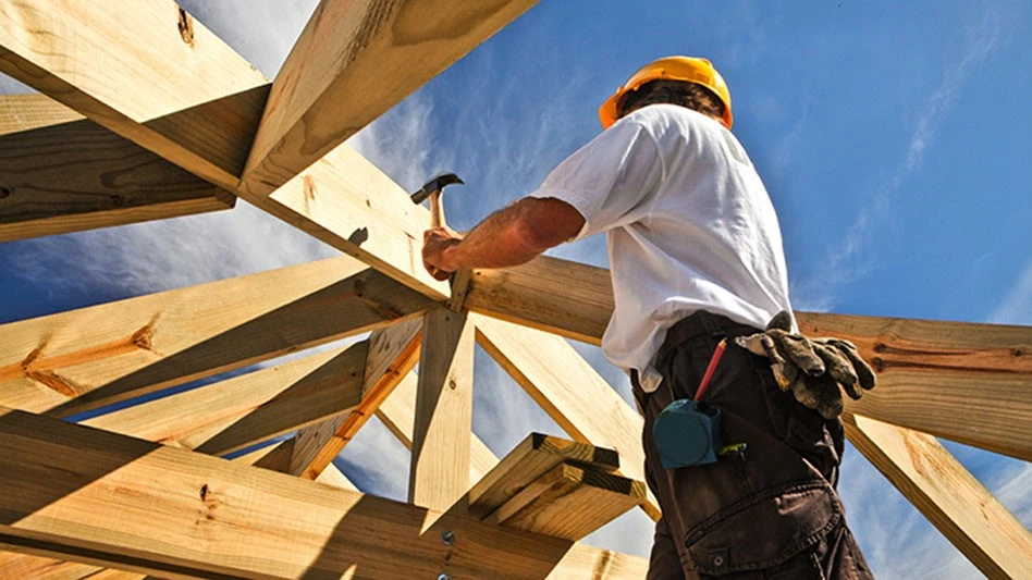 carpenter working on house frame