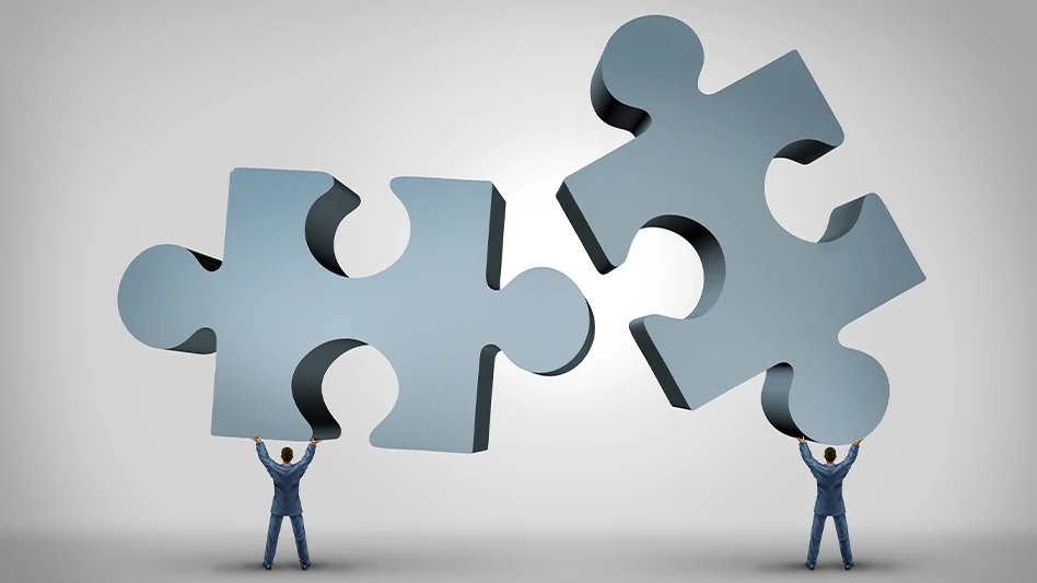 Two tiny businessmen holding up two giant gray puzzle pieces that they intend to fit together.