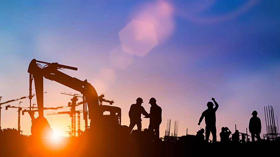 The sun sets on construction workers