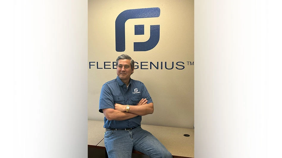 andreas gruson poses in front of fleetgenius logo