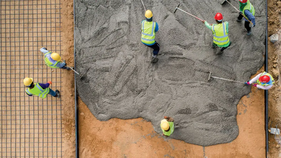 aerial view of workers pouring a concrete floor