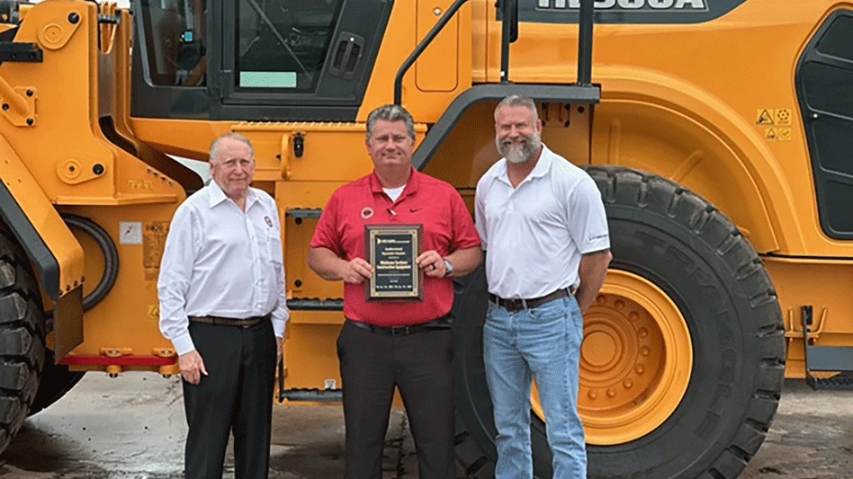 Dick Belger (left), president of Oklahoma Territory Construction Equipment, and Matt Simmons (center), OTCE business manager, accept their new Hyundai Construction Equipment dealership plaque from Matt Brown (right), Hyundai district manager.