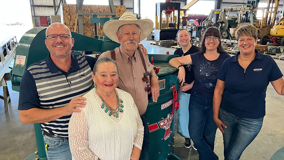 six people smiling in a warehouse
