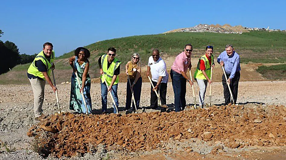 Eight people at a groundbreaking ceremony