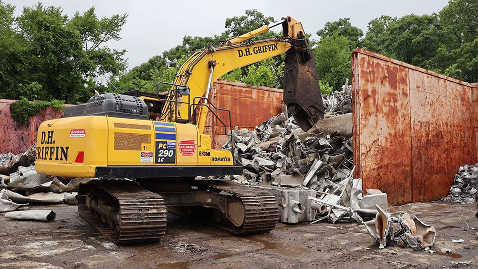 a shear mounted on a tracked compact excavator