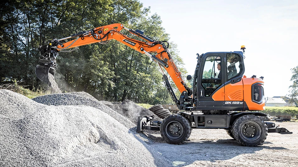 orange wheeled excavator working