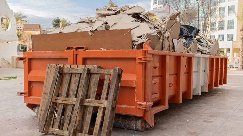 construction waste in an orange waste container