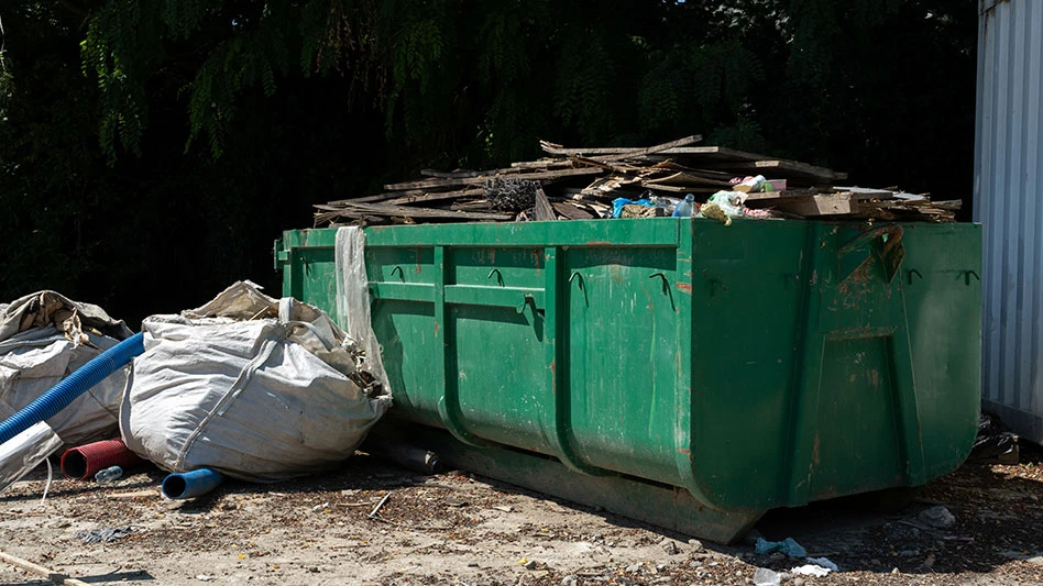 Rectangular open top roll off dumpster filled with C&D debris