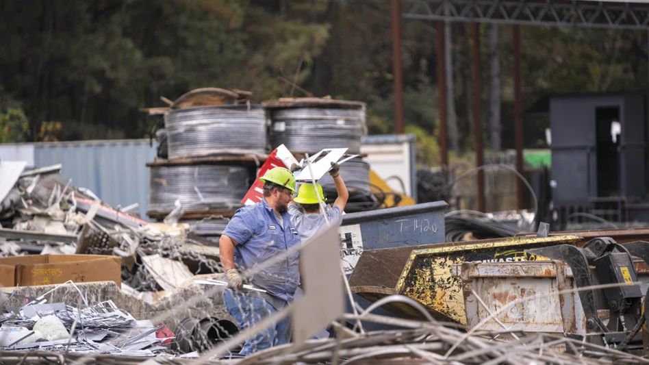 two men in yellow hardhats in demolition work zone