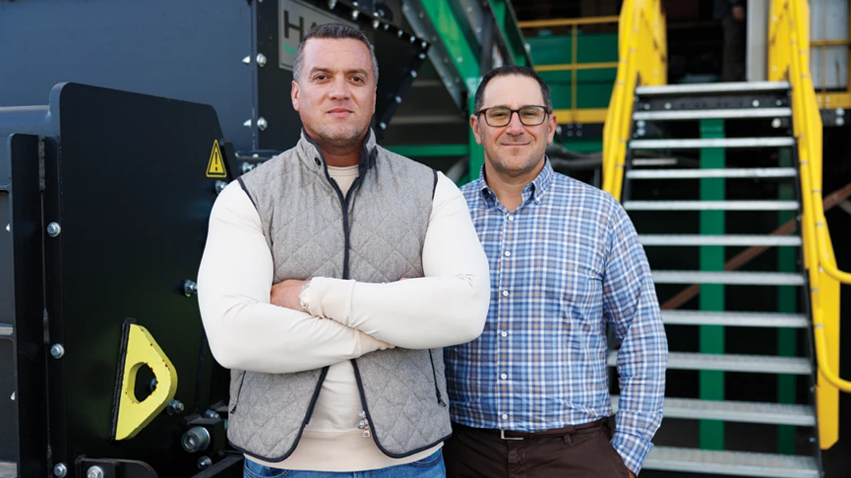 two men in front of equipment
