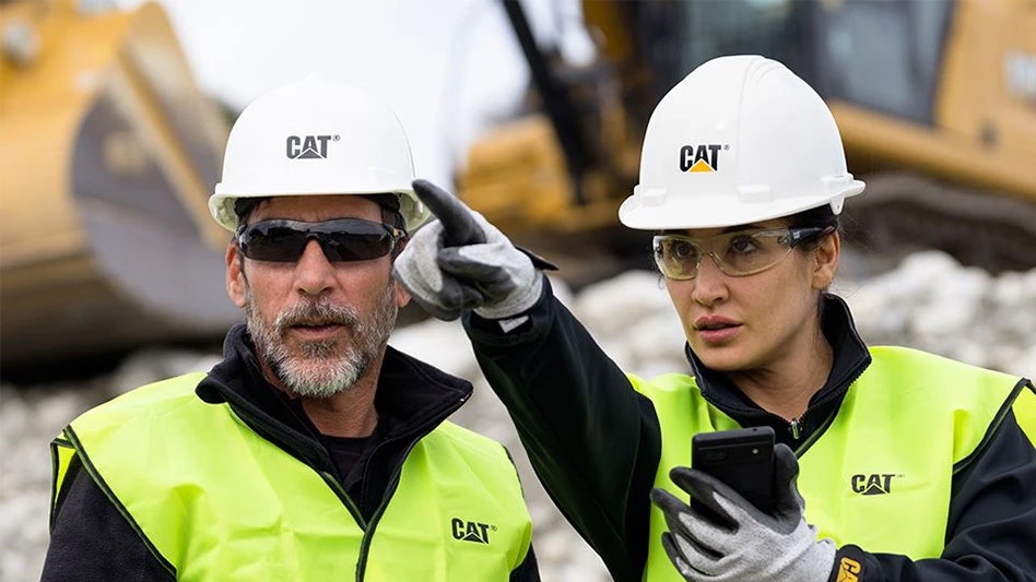 Two Caterpillar employees.