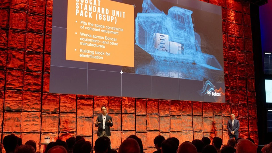 person speaking on stage giving presentation