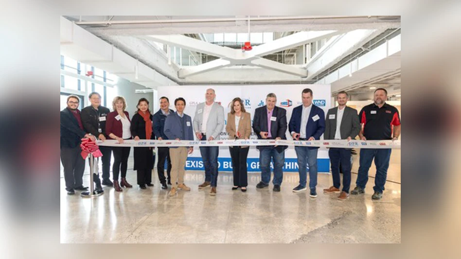 group of people standing at ribbon for ribbon cutting
