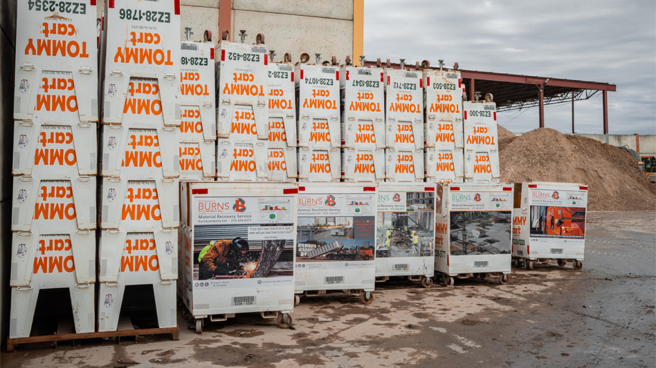 pile of white tommycart collection bins at recycling facility